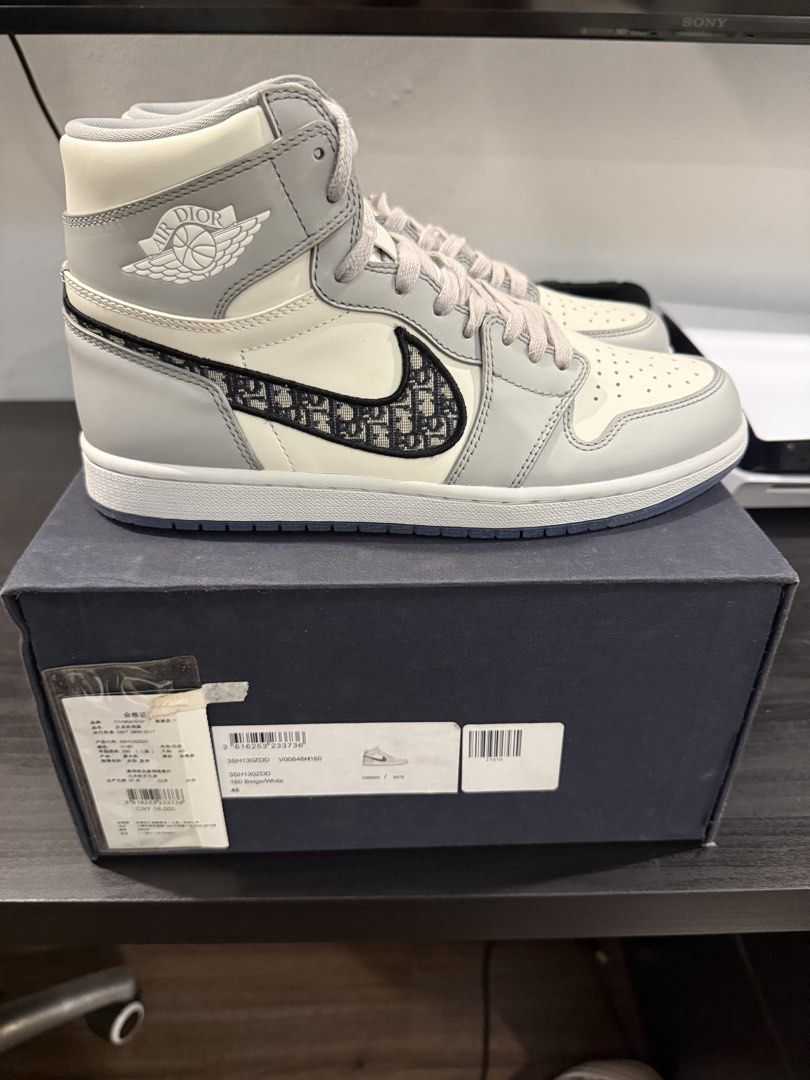 Air Jordan 1 High OG Dior (Category: Sneakers) located in Pasay City. Submitted by danmacaraeg (Listing ID 1471085582, Image 1). Description: - Model: Air Jordan 1 High OG Dior Collaboration - Size: US 11 / EU 45 - Condition: Brand new, completely unworn in crisp condition - Limited Edition: Individually numbered 3658 out of 8500 on the inner collar tab - Design: Premium white and grey leather upper featuring the iconic Dior Oblique jacquard Swoo