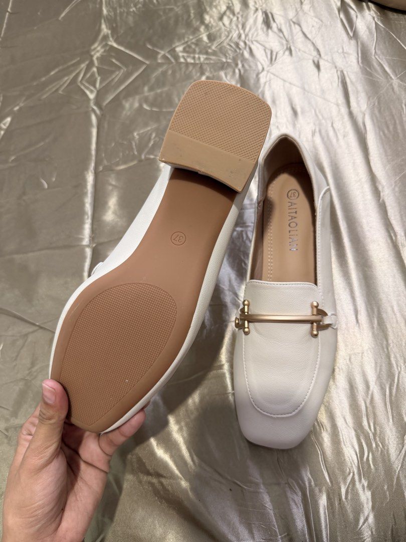 Aitaolian White Loafers Square Toe Size 37 (Category: Loafers) located in Baguio. Submitted by nabiwuh.06 (Listing ID 1471019430, Image 3). Description: - From Taiwan - Not my style and size - Original -Style: Square toe loafers with chic gold-tone hardware - Color: Classic white with a smooth synthetic leather finish - Heel: Comfortable low block heel for all-day wear - Size: 37 (stamped inside and on the sole) - Condition: Clean with pristine, 