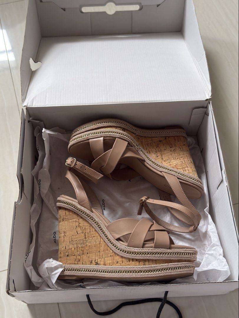 Aldo Nude Wedge Sandals with Box (Category: Wedges) located in Mabalacat. Submitted by mykachika (Listing ID 1471043689, Image 1). Description: - Brand: Aldo - Style: Nude wedge sandals with open toe and strappy design - Features: Cork-style heel and trendy braided chain trim detail - Closure: Buckle ankle closure - Condition: Once used for graduation - Inclusions: Comes in the original white shoe box with tissue paper.