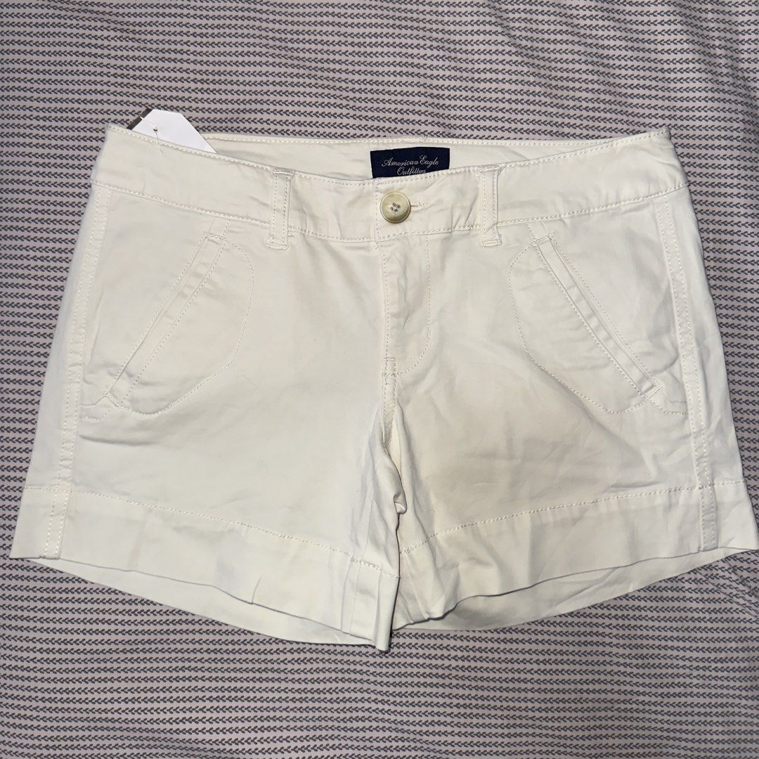 American Eagle Outfitters White Stretch Shorts (Category: Shorts) located in Santa Ana. Submitted by fatikilla (Listing ID 1470981382, Image 1). Description: - Brand: American Eagle Outfitters - Color: Classic White - Condition: Brand new with tags still attached - Material: Comfortable stretch fabric - Design: Front pockets, single button closure with zipper fly, and stylish folded hems - Style: Versatile everyday summer staple.