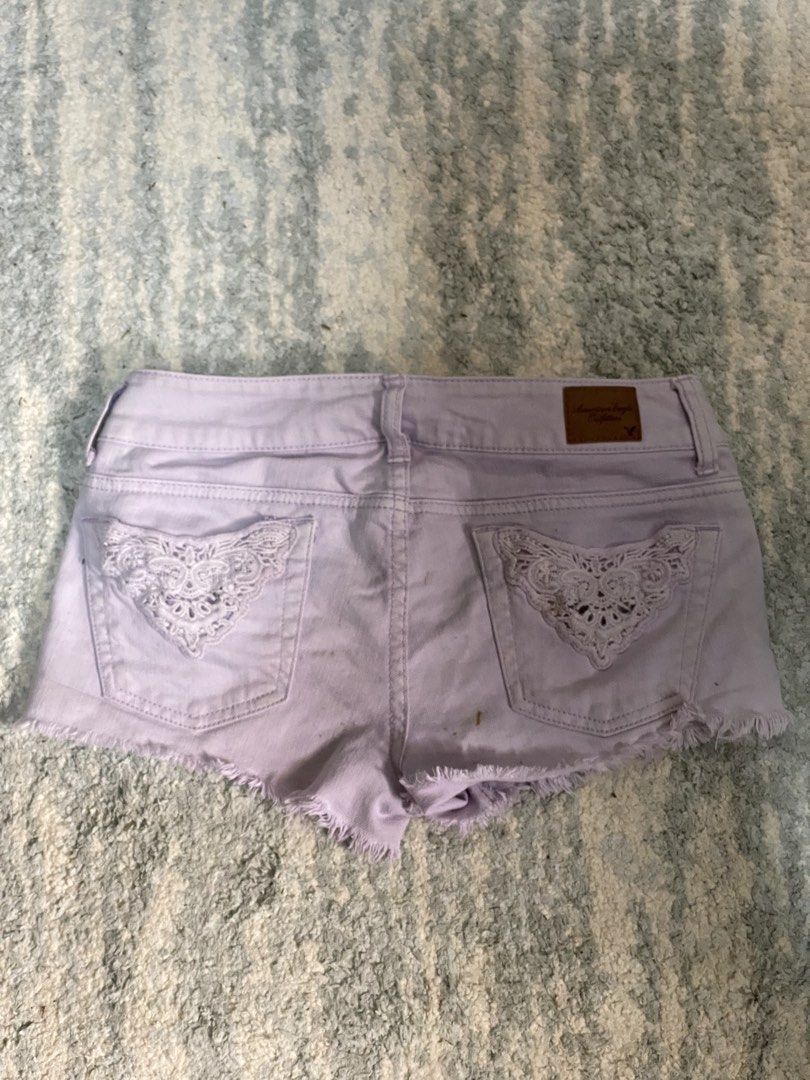 American Eagle Purple Stretch Denim Shorts (Category: Shorts) located in Manila. Submitted by kuya_moto (Listing ID 1470990291, Image 2). Description: - Brand: American Eagle - Color: Light purple - Fit: Low rise with comfortable stretch fabric - Details: Frayed raw hem, branded metal button closure, and leather patch on back waistband - Special Feature: Charming white lace applique on back pockets - Shipping: Ships fast from the Philippines via 