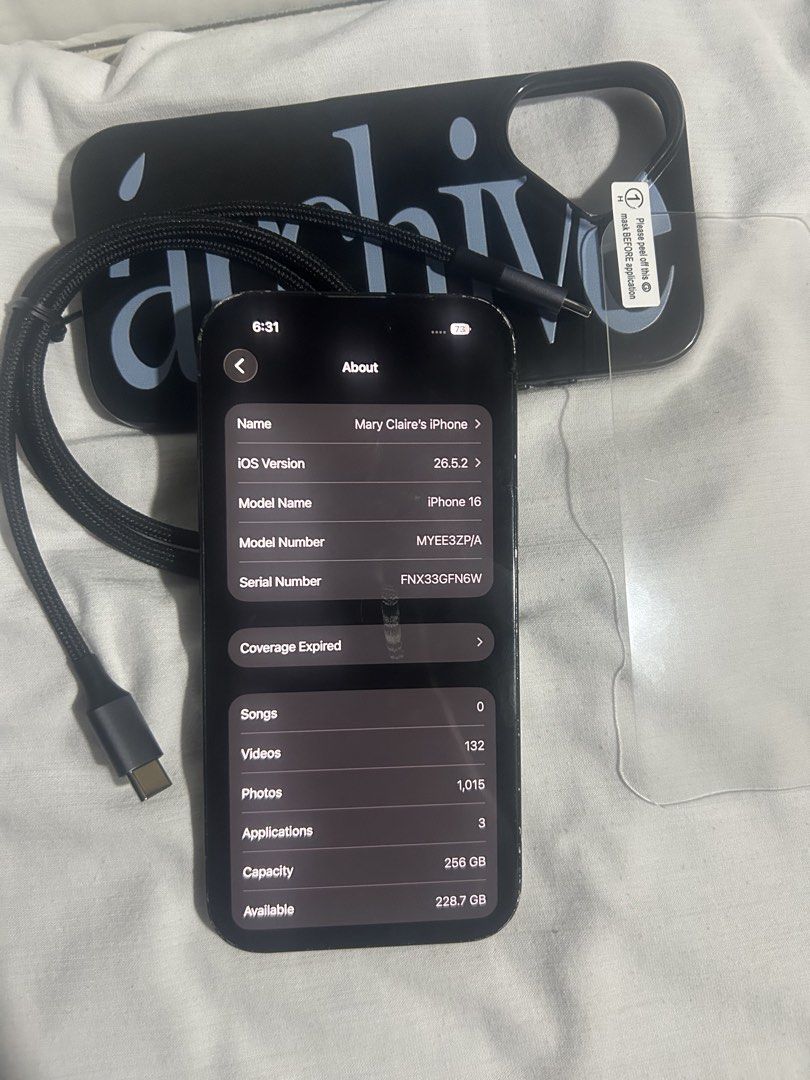 Apple iPhone 16 256GB Black Unlocked (Category: iPhone 16 Series) located in Manila. Submitted by maryclaire61487 (Listing ID 1471035083, Image 1). Description: - Model: Apple iPhone 16 (MYEE3ZP/A, Serial: FNX33GFNW) - Storage: 256GB - Color: Black - Condition: Fully functional, with visible scuffs and wear along the edges and housing frame - Network: Factory unlocked (no SIM restrictions) - Inclusions: Charging cable, black text phone case, and 
