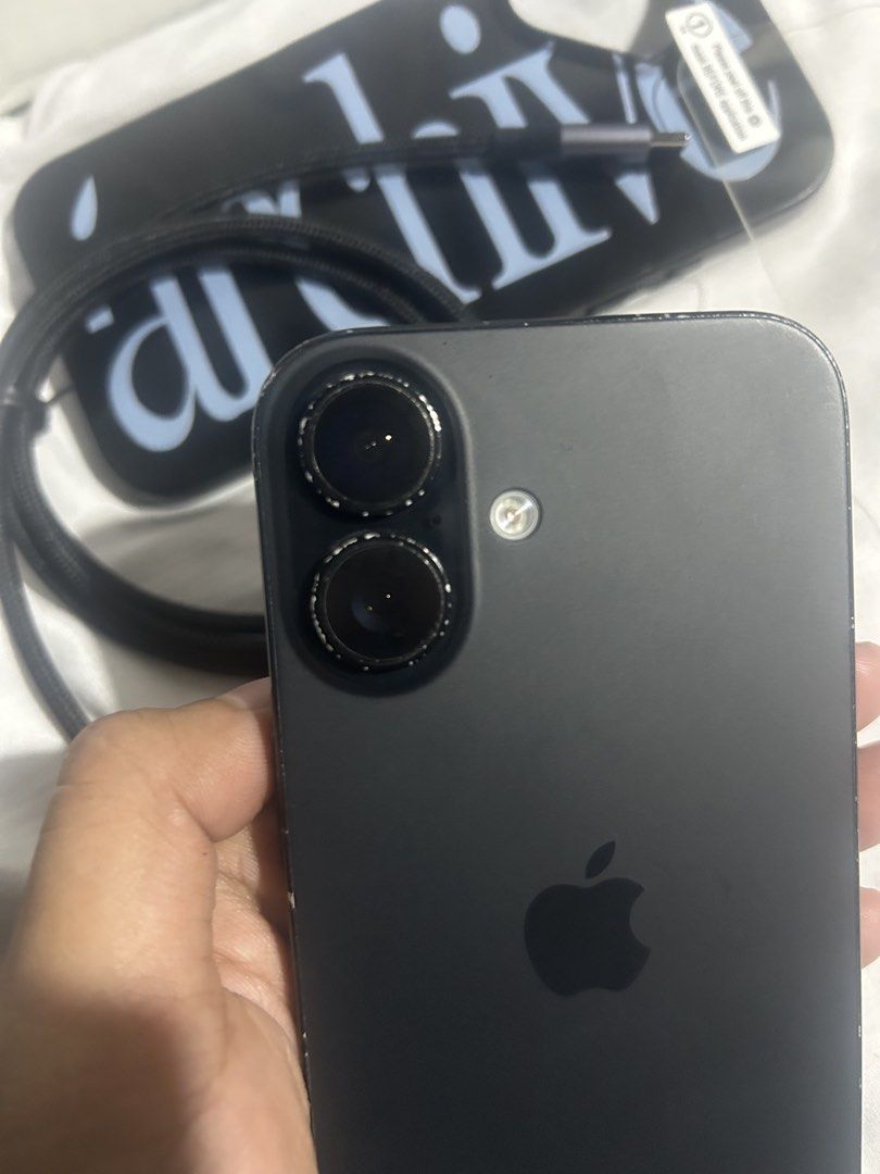Apple iPhone 16 256GB Black Unlocked (Category: iPhone 16 Series) located in Manila. Submitted by maryclaire61487 (Listing ID 1471035083, Image 3). Description: - Model: Apple iPhone 16 (MYEE3ZP/A, Serial: FNX33GFNW) - Storage: 256GB - Color: Black - Condition: Fully functional, with visible scuffs and wear along the edges and housing frame - Network: Factory unlocked (no SIM restrictions) - Inclusions: Charging cable, black text phone case, and 
