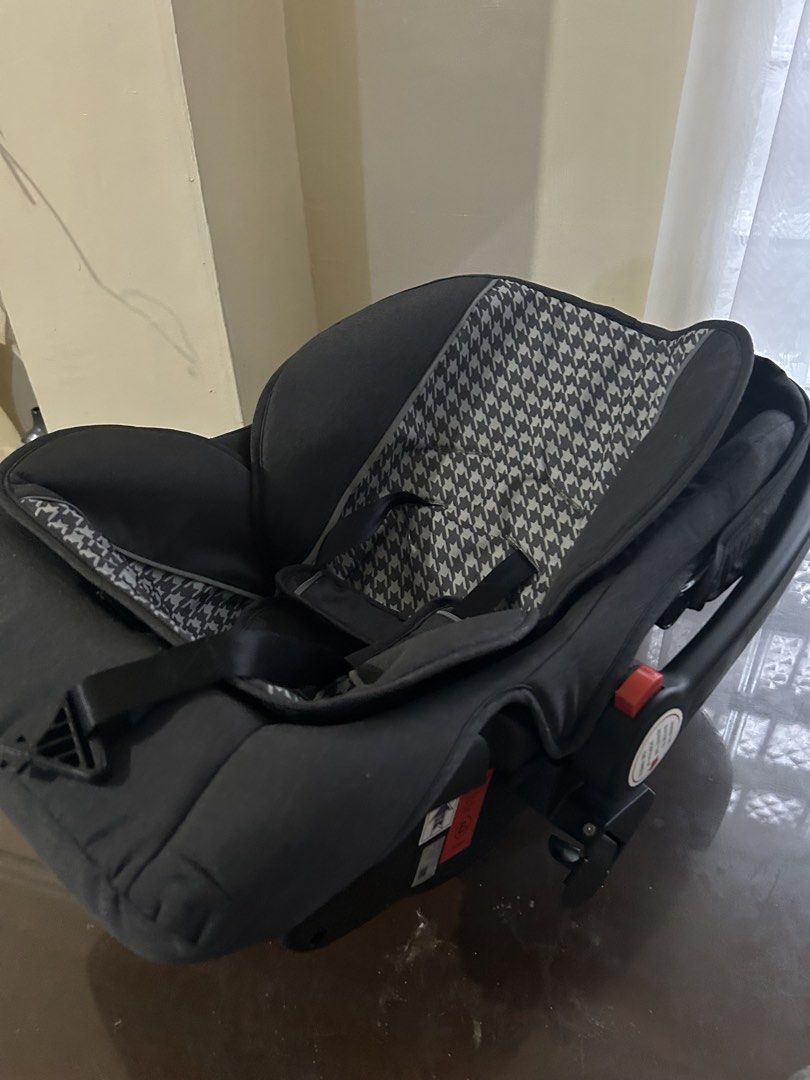 Apruva Infant Car Seat Grey Houndstooth (Category: Car Seats) located in Manila. Submitted by jovy_mae (Listing ID 1470996980, Image 2). Description: - Brand: Apruva Baby Car Seat - Color/Design: Chic grey with a trendy houndstooth pattern cushion - Safety: Built-in harness straps, central buckle, safety certification labels, and side airbag warning sticker - Convenience: Adjustable carry handle with red release buttons on both sides and an attac