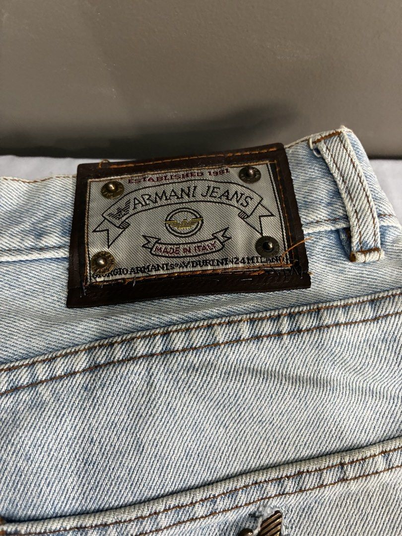 Armani Jeans Light Wash Denim (Category: Jeans) located in Manila. Submitted by nikkoour (Listing ID 1470934512, Image 2). Description: - Brand: Armani Jeans (Est. 1981 line) - Origin: Made in Italy - Wash: Light wash with subtle distressing - Fit: Casual straight leg - Details: Button fly, metal rivets, classic back pocket stitching with eagle logo - Branding: Iconic leather patch on the back waistband - Condition: Great vintage look -32.