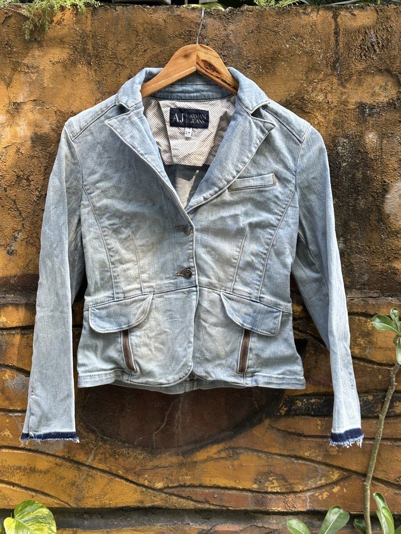 Armani Jeans Light Wash Denim Blazer Jacket (Category: Coats, Jackets and Outerwear) located in Urdaneta. Submitted by redeemedcollective (Listing ID 1471063884, Image 1). Description: Armani Jeans (AJ) Light-wash denim blazer featuring a tailored silhouette, notched lapels, branded metal buttons, and contrasting dark denim accents at the sleeve cuffs. Details: • Light blue washed denim • Tailored, structured silhouette • Two-button front closure