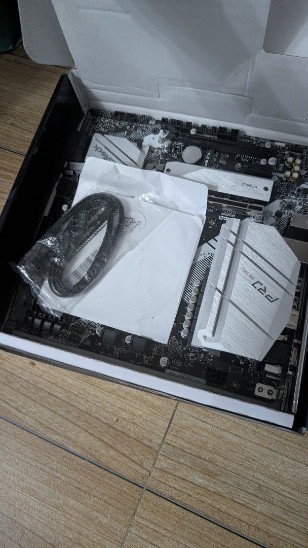 ASRock B550M Pro4 Motherboard (Category: Computer Parts) located in Rizal. Submitted by lperezjr03 (Listing ID 1470972856, Image 2). Description: - Model: ASRock B550M Pro4 (AMD AM4 socket) - Compatibility: Supports Ryzen 5000 series desktop processors - Aesthetics: Clean PCB with stylish silver heatsinks over VRM and M.2 slots - Inclusions: Comes complete with original box, manual packaging, and SATA cables - Condition: Excellent, ideal for a re