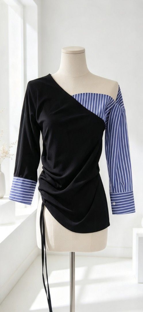 Asymmetric Blue Striped And Black Blouse (Category: Blouses) located in Manila. Submitted by charlottej01596 (Listing ID 1470965762, Image 1). Description: - Unique asymmetric design mixing solid black and blue-white striped sleeves - Trendy off-shoulder cut on one side - Adjustable drawstring detail at the side seam for a customized bodycon fit - Structured button cuffs for a polished finish - Versatile statement piece ideal for dinners and casu