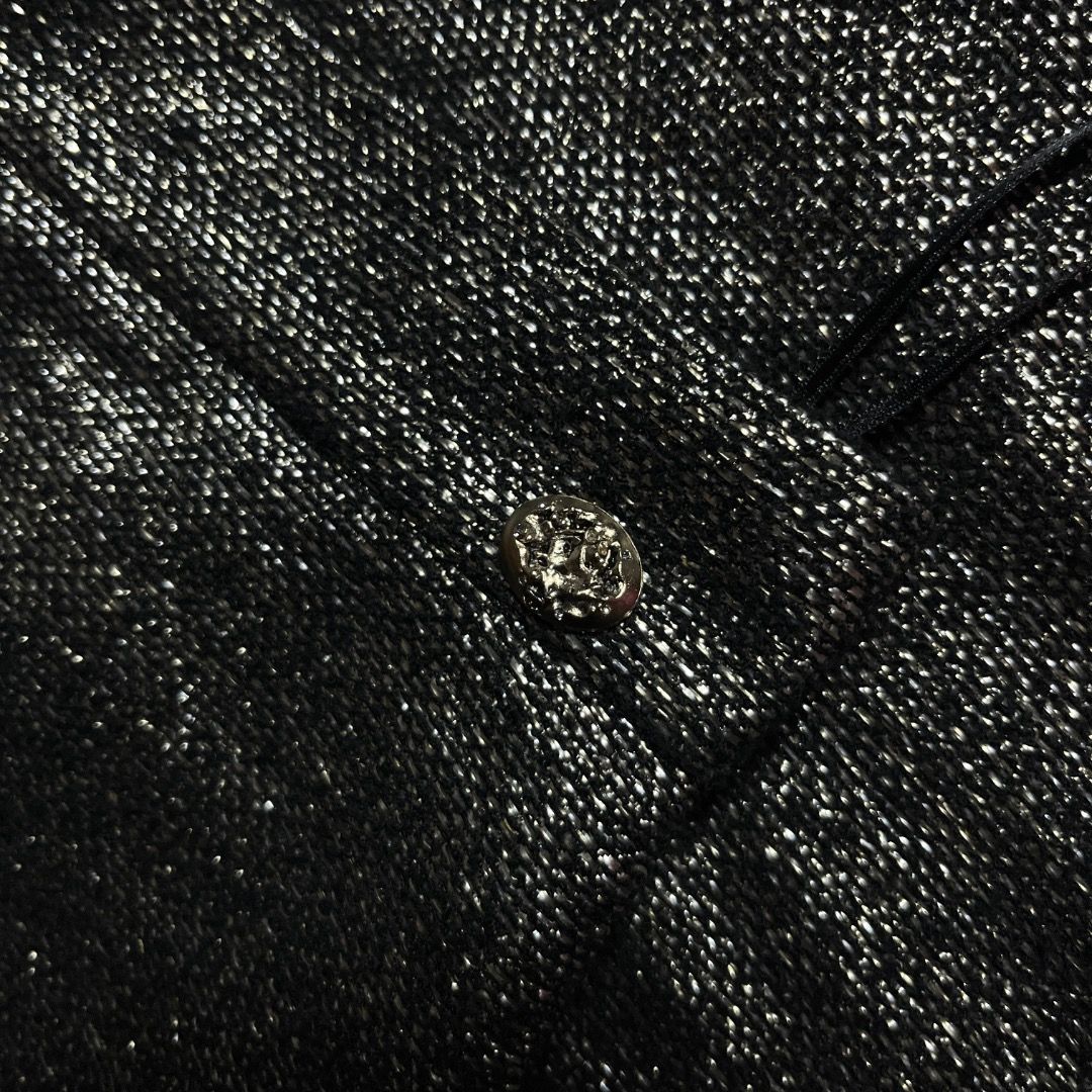 Authentic Chanel Metallic Black Two-Piece Skirt Set (Category: Sets or Coordinates) located in Caloocan City. Submitted by achilles_grails (Listing ID 1471056494, Image 2). Description: - Brand: Chanel - Type: Matching set (Short-sleeve top & wrap mini skirt) - Color: Metallic black with textured glitter finish - Details: Embellished button accents on the skirt - Origin: Made in France - Sizing: Top is Size 34, Skirt is Size 36 - Condition: Excel