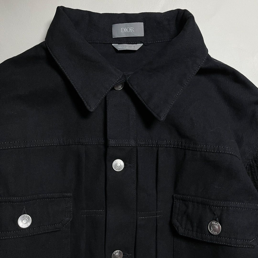 Authentic Dior Black Denim Jacket with Knit Sleeves (Category: Coats, Jackets and Outerwear) located in Caloocan City. Submitted by achilles_grails (Listing ID 1471078364, Image 3). Description: - 100% Authentic Dior black denim jacket, made in Italy - Unique ribbed knit black sleeves and collar - Button-up front with branded silver metal hardware - Two functional chest flap pockets - Large embroidered Dior logo on the back with a safety pin grap
