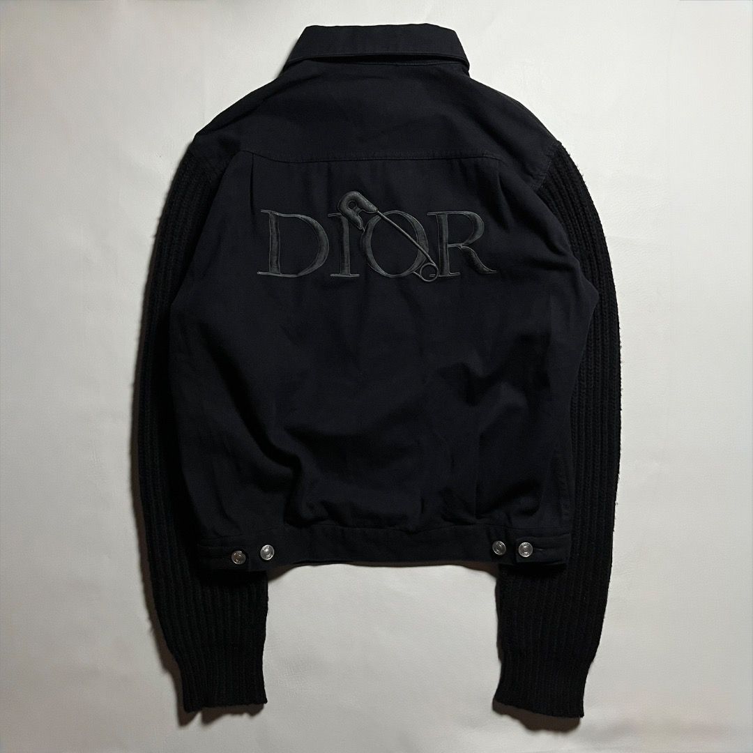 Authentic Dior Black Denim Jacket with Knit Sleeves (Category: Coats, Jackets and Outerwear) located in Caloocan City. Submitted by achilles_grails (Listing ID 1471078364, Image 2). Description: - 100% Authentic Dior black denim jacket, made in Italy - Unique ribbed knit black sleeves and collar - Button-up front with branded silver metal hardware - Two functional chest flap pockets - Large embroidered Dior logo on the back with a safety pin grap