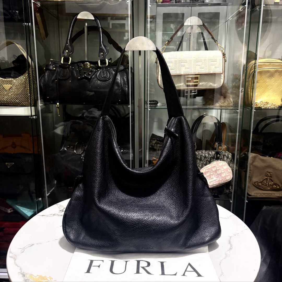 Authentic Furla Black Genuine Leather Hobo Bag (Category: Luxury Bags & Wallets) located in Binangonan. Submitted by makoleksyon (Listing ID 1471051079, Image 1). Description: Excellent condition Like new No flaws With dust bag included Size: H-12 x W-17 x D-5.5 inches Bought in Japan 💯% Authentic Money back guarantee .