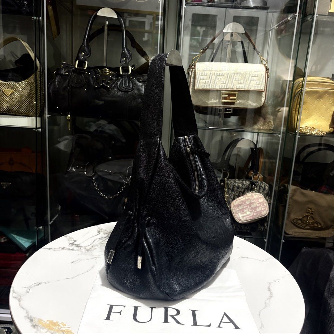 Authentic Furla Black Genuine Leather Hobo Bag (Category: Luxury Bags & Wallets) located in Binangonan. Submitted by makoleksyon (Listing ID 1471051079, Image 2). Description: Excellent condition Like new No flaws With dust bag included Size: H-12 x W-17 x D-5.5 inches Bought in Japan 💯% Authentic Money back guarantee .