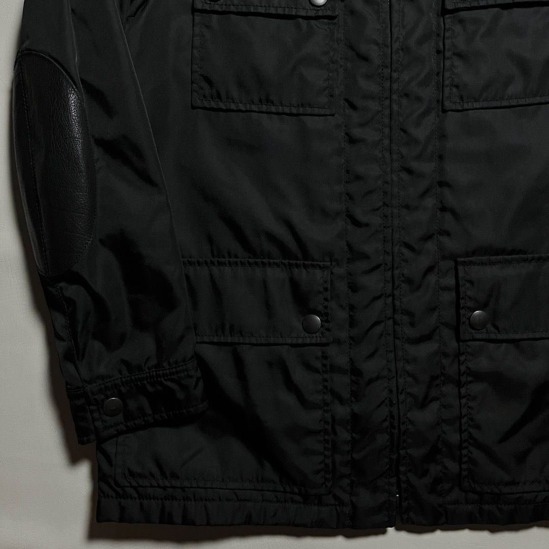 Authentic Prada Black Nylon Utility Jacket with Leather Accents (Category: Luxury Apparel) located in Caloocan City. Submitted by achilles_grails (Listing ID 1471039912, Image 3). Description: - Authentic Prada nylon utility jacket in classic black - Full front zip closure with high funnel neck and snap buttons - Multiple practical cargo pockets and zippered compartments - Stylish textured leather panels on shoulders and elbow patches - Premium b
