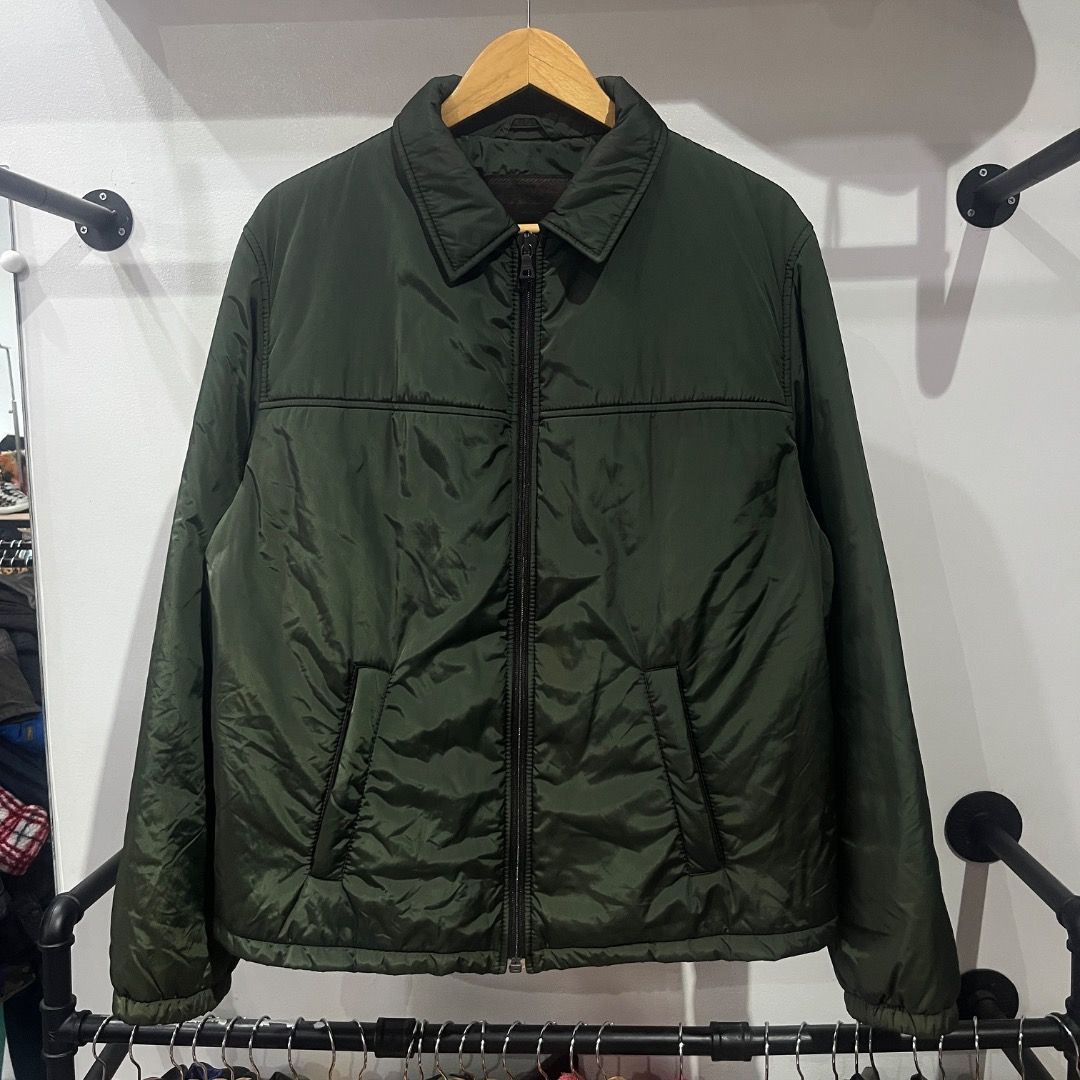 Authentic Prada Dark Green Insulated Harrington Jacket (Category: Coats, Jackets and Outerwear) located in Caloocan City. Submitted by achilles_grails (Listing ID 1471028356, Image 1). Description: - Color: Dark green - Size: XL - Style: Zip-up jacket with classic collar and clean chest stitching - Warmth: Quilted puffer lining for extra insulation - Features: Two front slanted pockets, ribbed cuffs, and hem to block the wind - Condition: Smooth 