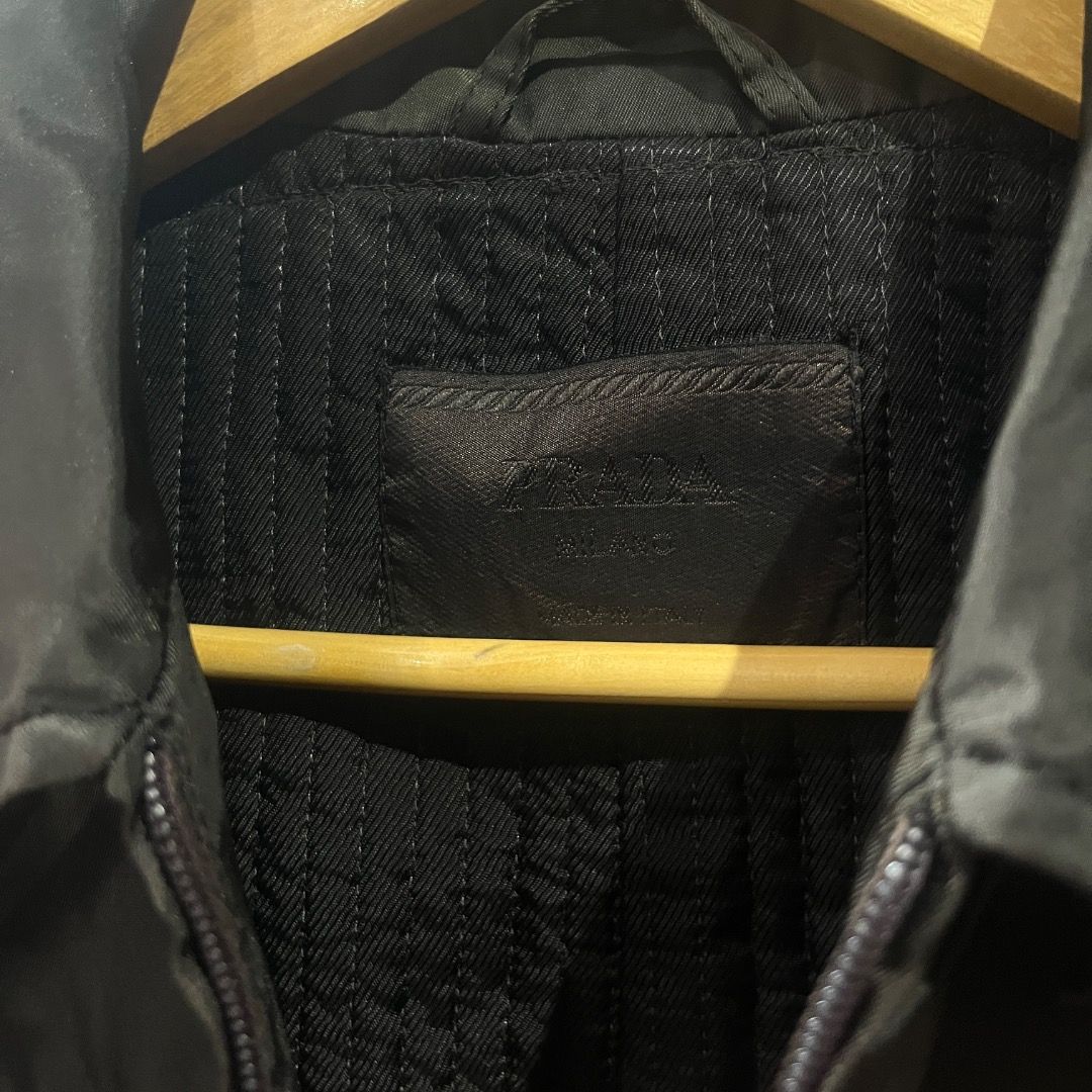Authentic Prada Nylon Belted Trench Coat (Category: Coats, Jackets and Outerwear) located in Caloocan City. Submitted by achilles_grails (Listing ID 1471028182, Image 3). Description: - Brand: Prada - Color: Classic Black - Material: Lightweight nylon - Features: Full front zip closure, pointed collar, and long sleeves - Included: Matching fabric belt with silver-tone Prada-engraved buckle - Style: Timeless layering piece.