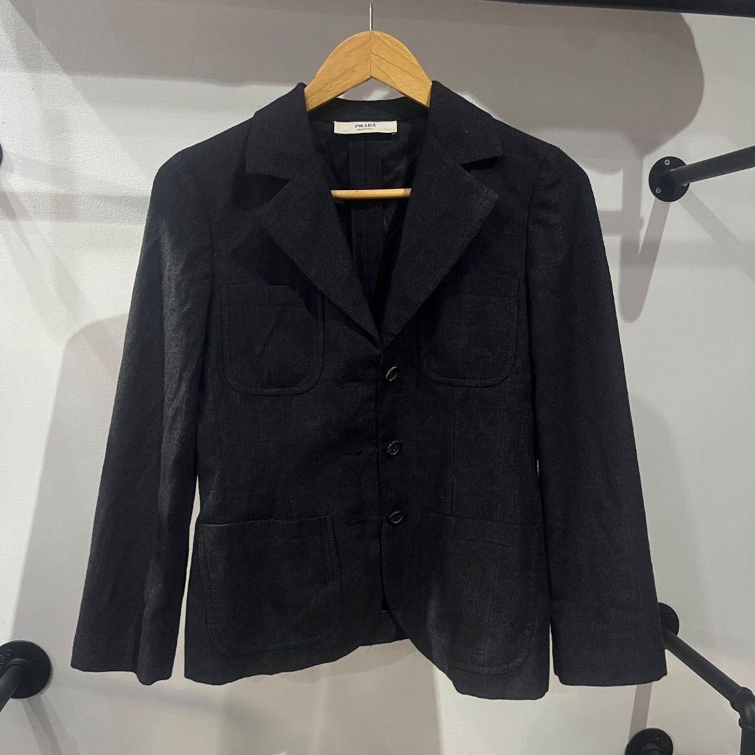 Authentic Prada Plaid Virgin Wool Cashmere Blazer Size 40 (Category: Coats, Jackets and Outerwear) located in Caloocan City. Submitted by achilles_grails (Listing ID 1471028058, Image 1). Description: - Brand: Prada - Color: Dark charcoal black - Size: Italian 40 - Material: 92% virgin wool, 8% cashmere (Made in Italy) - Features: Structured lapels, front button closure, flap pockets, fully lined interior - Condition: Premium tailoring, timeless 