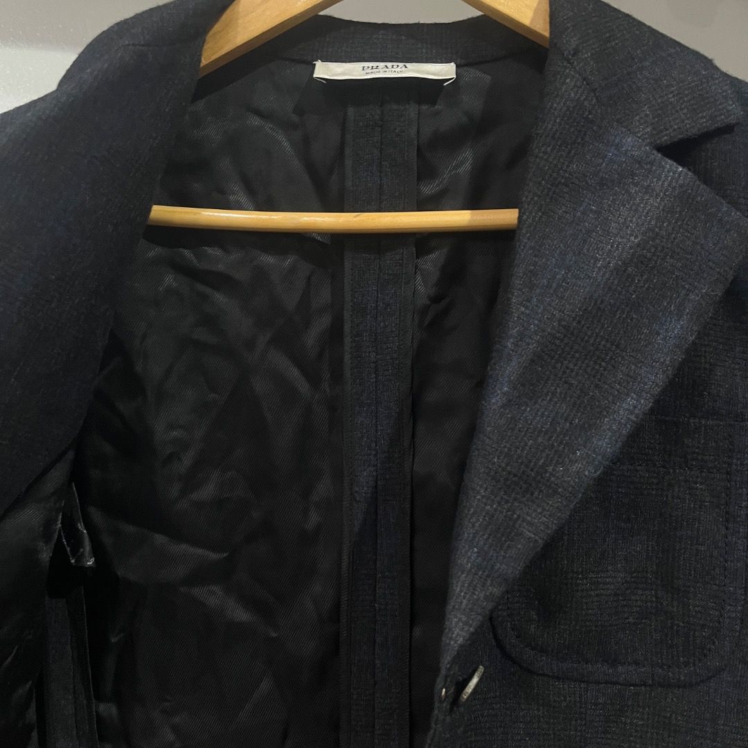 Authentic Prada Plaid Virgin Wool Cashmere Blazer Size 40 (Category: Coats, Jackets and Outerwear) located in Caloocan City. Submitted by achilles_grails (Listing ID 1471028058, Image 3). Description: - Brand: Prada - Color: Dark charcoal black - Size: Italian 40 - Material: 92% virgin wool, 8% cashmere (Made in Italy) - Features: Structured lapels, front button closure, flap pockets, fully lined interior - Condition: Premium tailoring, timeless 