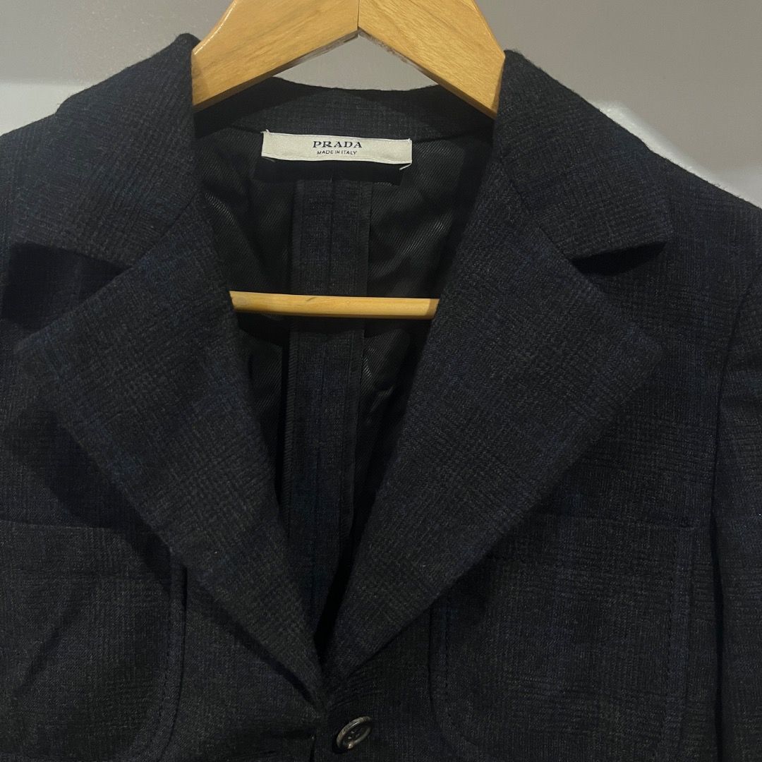 Authentic Prada Plaid Virgin Wool Cashmere Blazer Size 40 (Category: Coats, Jackets and Outerwear) located in Caloocan City. Submitted by achilles_grails (Listing ID 1471028058, Image 2). Description: - Brand: Prada - Color: Dark charcoal black - Size: Italian 40 - Material: 92% virgin wool, 8% cashmere (Made in Italy) - Features: Structured lapels, front button closure, flap pockets, fully lined interior - Condition: Premium tailoring, timeless 