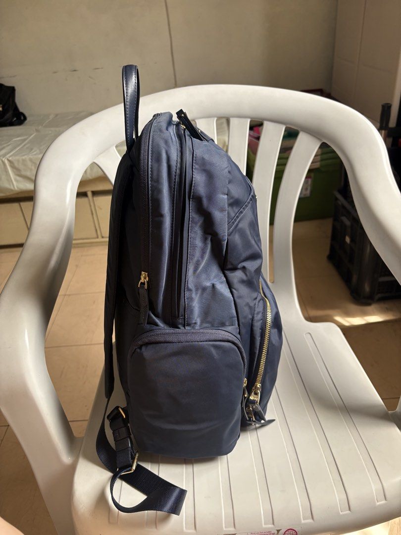 Authentic TUMI Navy Blue Nylon Backpack with Gold Hardware (Category: Backpacks) located in Quezon City. Submitted by rottiemom (Listing ID 1470967298, Image 3). Description: - Brand: Tumi - Color: Dark Navy Blue with polished gold hardware - Material: Durable signature nylon with leather top handle - Compartments: 1 laptop compartment, roomy main compartment, front zipped pocket, and 2 side pockets - Comfort: Adjustable padded shoulder straps - 