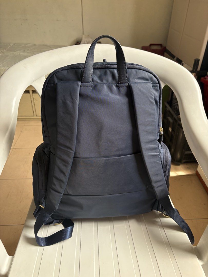 Authentic TUMI Navy Blue Nylon Backpack with Gold Hardware (Category: Backpacks) located in Quezon City. Submitted by rottiemom (Listing ID 1470967298, Image 2). Description: - Brand: Tumi - Color: Dark Navy Blue with polished gold hardware - Material: Durable signature nylon with leather top handle - Compartments: 1 laptop compartment, roomy main compartment, front zipped pocket, and 2 side pockets - Comfort: Adjustable padded shoulder straps - 