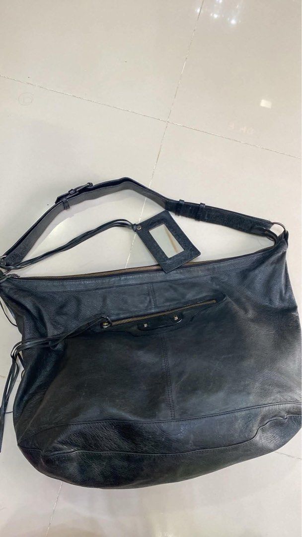 Balenciaga Black Leather Shoulder Bag (Category: Luxury Bags & Wallets) located in Bacolod City. Submitted by chuchaystuffs (Listing ID 1470944358, Image 2). Description: - Balenciaga black leather shoulder bag/hobo tote - Crafted from ultra-soft crinkled leather - Features edgy zipper pockets and tassel details - Includes original hanging mirror - Interior tag: Balenciaga Paris (Made in Italy, Style No: 173084 502752) - Spacious design, perfect 