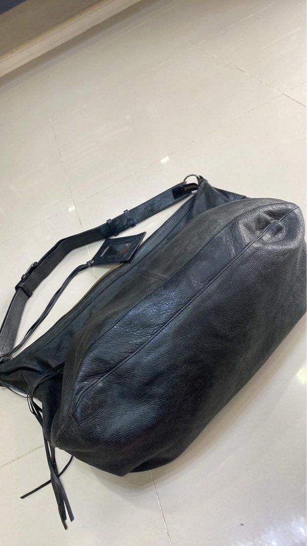Balenciaga Black Leather Shoulder Bag (Category: Luxury Bags & Wallets) located in Bacolod City. Submitted by chuchaystuffs (Listing ID 1470944358, Image 3). Description: - Balenciaga black leather shoulder bag/hobo tote - Crafted from ultra-soft crinkled leather - Features edgy zipper pockets and tassel details - Includes original hanging mirror - Interior tag: Balenciaga Paris (Made in Italy, Style No: 173084 502752) - Spacious design, perfect 