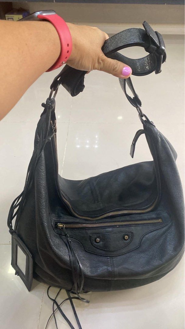 Balenciaga Black Leather Shoulder Bag (Category: Luxury Bags & Wallets) located in Bacolod City. Submitted by chuchaystuffs (Listing ID 1470944358, Image 1). Description: - Balenciaga black leather shoulder bag/hobo tote - Crafted from ultra-soft crinkled leather - Features edgy zipper pockets and tassel details - Includes original hanging mirror - Interior tag: Balenciaga Paris (Made in Italy, Style No: 173084 502752) - Spacious design, perfect 