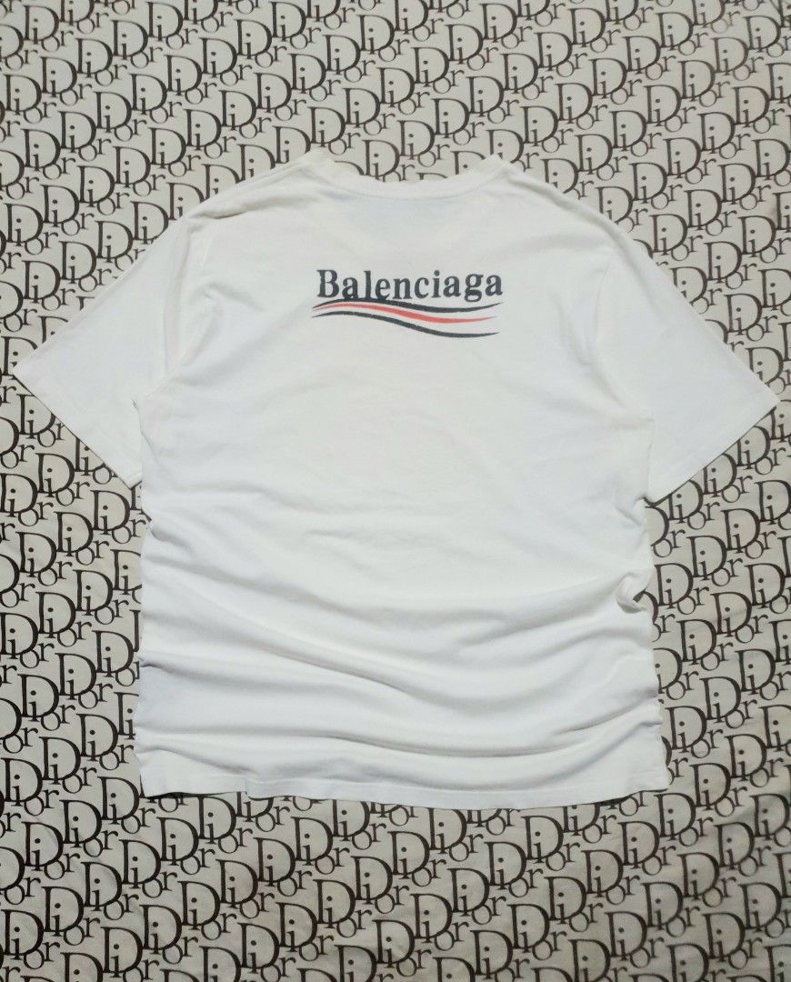 Balenciaga white campaign logo (Category: Tshirts & Polo Shirts ) located in San Fernando. Submitted by retro.district. (Listing ID 1471106661, Image 1). Description: - Balenciaga campaign logo - Size: Large(22x29) - Condition: Excellent - Issue: hairlines.