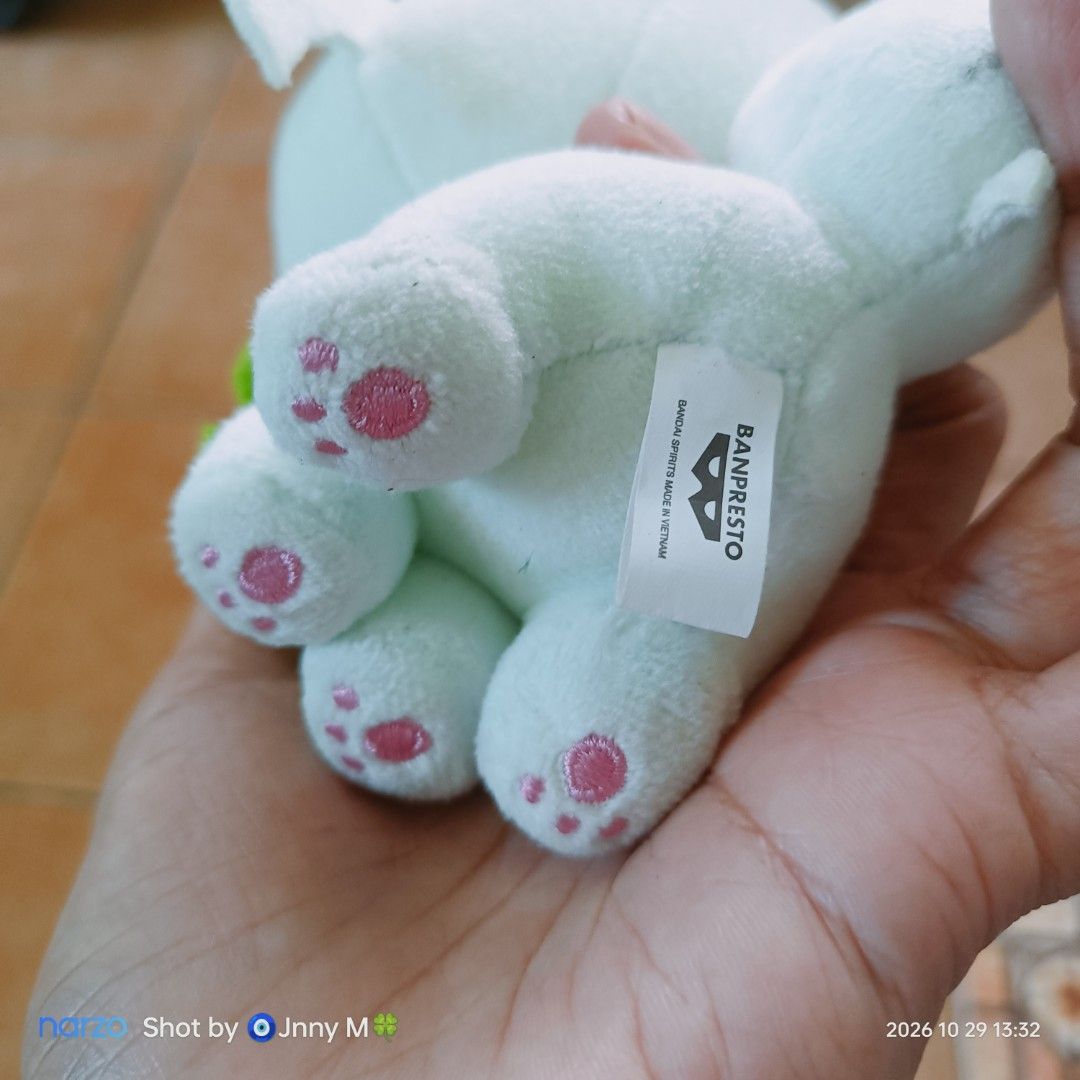 Banpresto Sprigatito Pokémon Plush Toy (Category: Plushies & Soft Toys) located in Taguig. Submitted by mhayestufftoys (Listing ID 1470987741, Image 3). Description: - Authentic Banpresto Pokémon Sprigatito plush toy with official tag attached - Palm-sized and compact, fits easily in your hand - High-quality embroidered facial details and adorable pink paw pads - Includes a convenient hanging loop at the top for easy display - Soft green and whit
