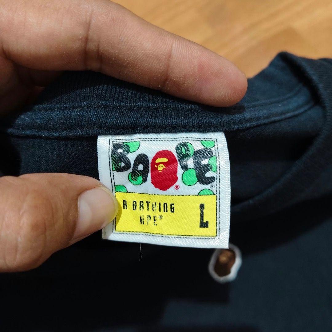 BAPE ONE POINT SHIRT FOR SALE (Category: Tshirts & Polo Shirts ) located in Caloocan City. Submitted by klozet.ph2026 (Listing ID 1471046029, Image 2). Description: - Brand: A Bathing Ape (Bape) - Color: Solid Black - Size: Large (Regular fit) - Design: Small embroidered ape head logo on the chest - Details: Classic Bape neck tag and sleeve tag attached - Material: 100% Cotton - Condition: Clean and well-maintained - Style: Perfect for everyday s