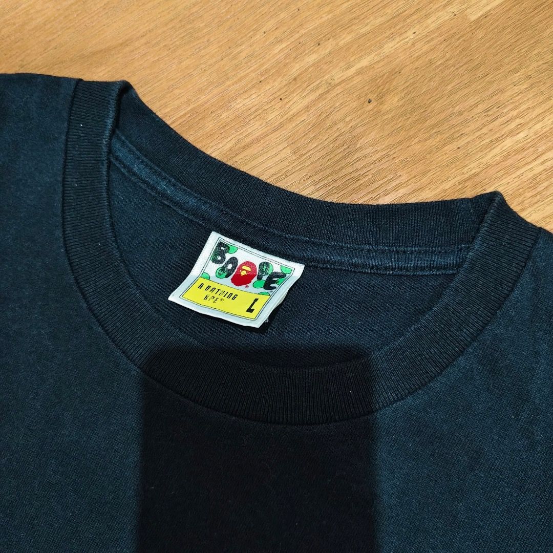 BAPE ONE POINT SHIRT FOR SALE (Category: Tshirts & Polo Shirts ) located in Caloocan City. Submitted by klozet.ph2026 (Listing ID 1471046029, Image 3). Description: - Brand: A Bathing Ape (Bape) - Color: Solid Black - Size: Large (Regular fit) - Design: Small embroidered ape head logo on the chest - Details: Classic Bape neck tag and sleeve tag attached - Material: 100% Cotton - Condition: Clean and well-maintained - Style: Perfect for everyday s