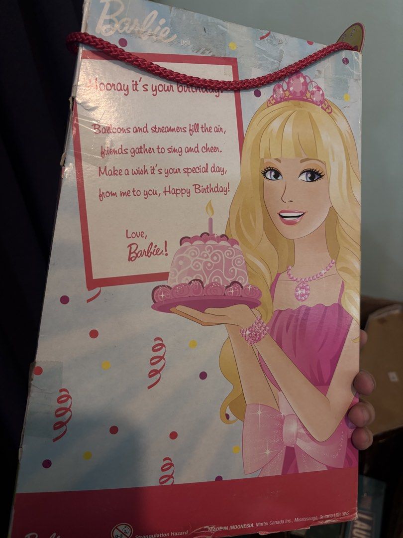 Barbie Happy Birthday Doll in Box (Category: Kids Toys) located in Davao. Submitted by dollznskullz (Listing ID 1470955880, Image 2). Description: - 100% Original packaging box with a cute birthday cake graphic on the front - Barbie comes with gorgeous blonde hair, a pink tiara, and a stunning pink gown with a large bow - Features a sweet birthday greeting message from Barbie printed on the back of the box - Equipped with a red braided carrying c