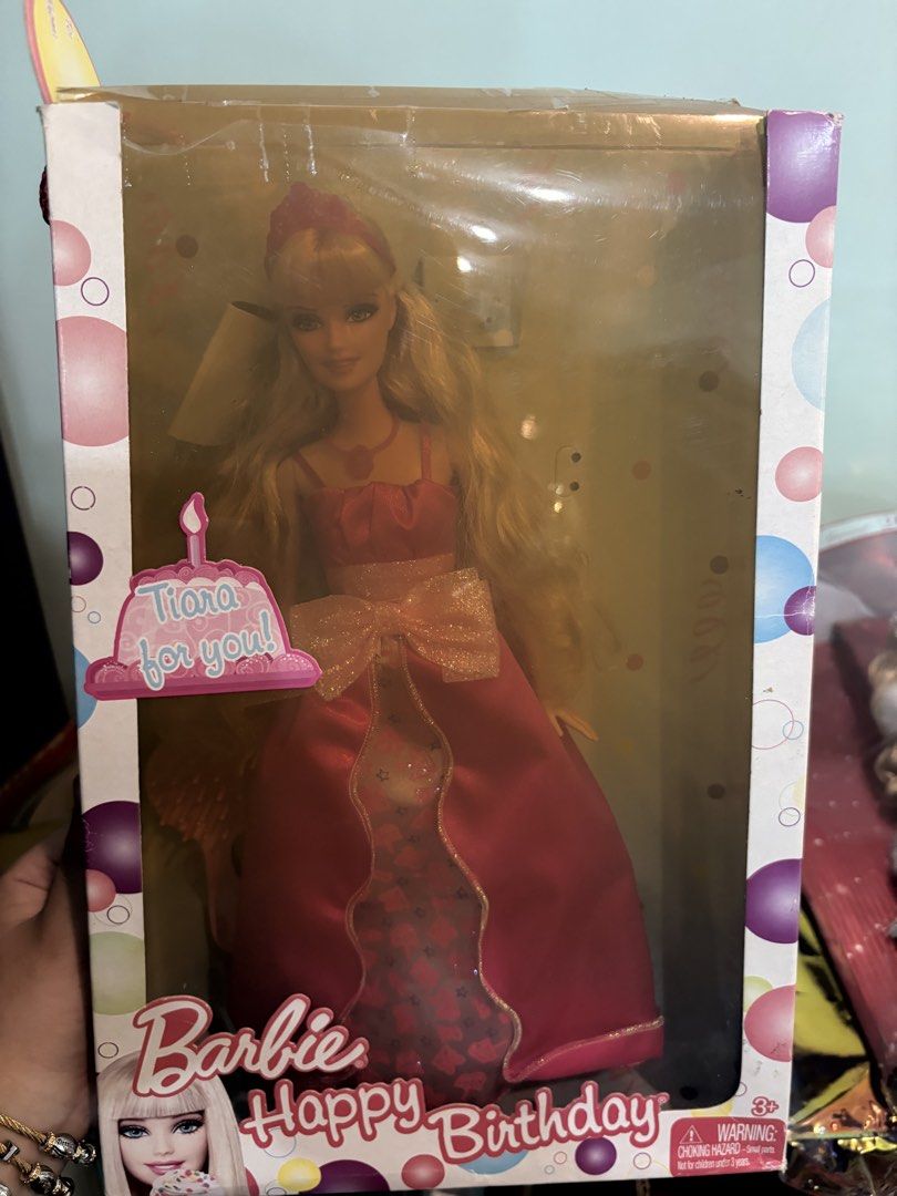 Barbie Happy Birthday Doll in Box (Category: Kids Toys) located in Davao. Submitted by dollznskullz (Listing ID 1470955880, Image 1). Description: - 100% Original packaging box with a cute birthday cake graphic on the front - Barbie comes with gorgeous blonde hair, a pink tiara, and a stunning pink gown with a large bow - Features a sweet birthday greeting message from Barbie printed on the back of the box - Equipped with a red braided carrying c