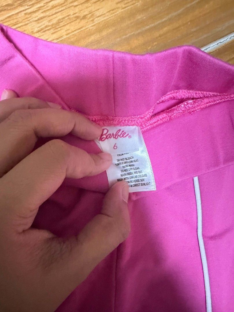 Barbie Pink Flare Pants Size 6 (Category: Babies & Kids Fashion) located in Manila. Submitted by enticexx (Listing ID 1471051105, Image 2). Description: - Color: Bright pink with white piping - Style: Flared cut with iconic Barbie silhouette logo near the hip - Size 6 .