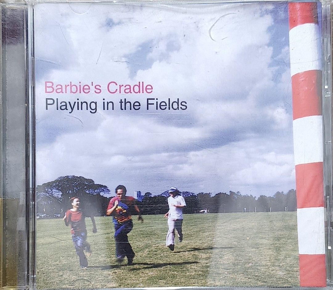 Barbie's Cradle Playing in the Fields CD (Category: CDs & DVDs) located in Manila. Submitted by ruelcabrer77078 (Listing ID 1471098340, Image 1). Description: - Artist & Album: Barbie's Cradle - Playing in the Fields - Release: Warner Music Philippines, 2003 - Inclusions: Original jewel case and CD - Tracklist includes: Ram Bam, Smiley, Pag-ibig, Dragonfly, and more (see back cover photo) - Condition: Disc surface has some markings written on it.