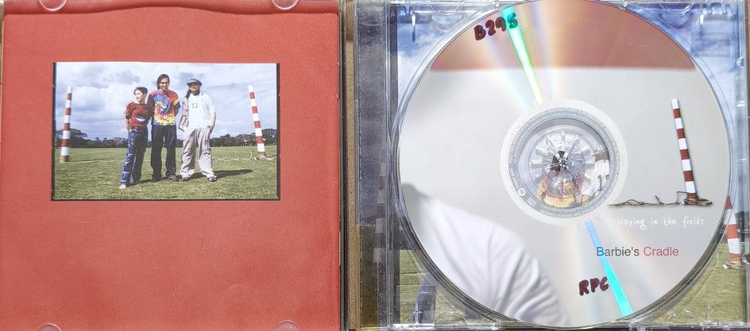 Barbie's Cradle Playing in the Fields CD (Category: CDs & DVDs) located in Manila. Submitted by ruelcabrer77078 (Listing ID 1471098340, Image 2). Description: - Artist & Album: Barbie's Cradle - Playing in the Fields - Release: Warner Music Philippines, 2003 - Inclusions: Original jewel case and CD - Tracklist includes: Ram Bam, Smiley, Pag-ibig, Dragonfly, and more (see back cover photo) - Condition: Disc surface has some markings written on it.
