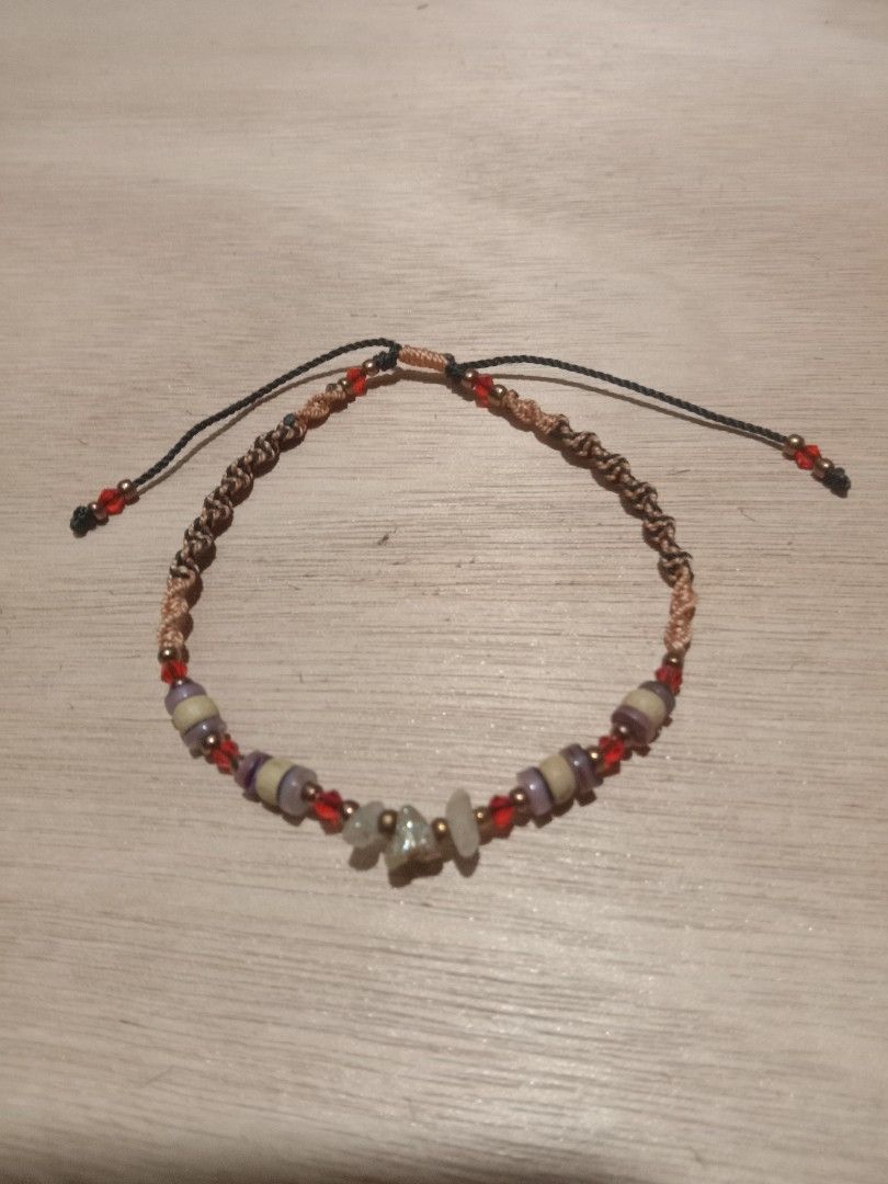 Beaded Macrame Cord anklet with Gemstone Chips (Category: Anklets) located in Danao, Cebu. Submitted by rennan.546 (Listing ID 1471097001, Image 1). Description: Rennan crafts anklet 📿💚 💛 ♥️ - Style: Earthy, bohemian macrame cord bracelet - Materials: Small gemstone chips, red crystal beads, and cylindrical stone spacers - Design: Brown and black woven string bands with adjustable sliding knots for a custom fit - Details: Finished with tiny re