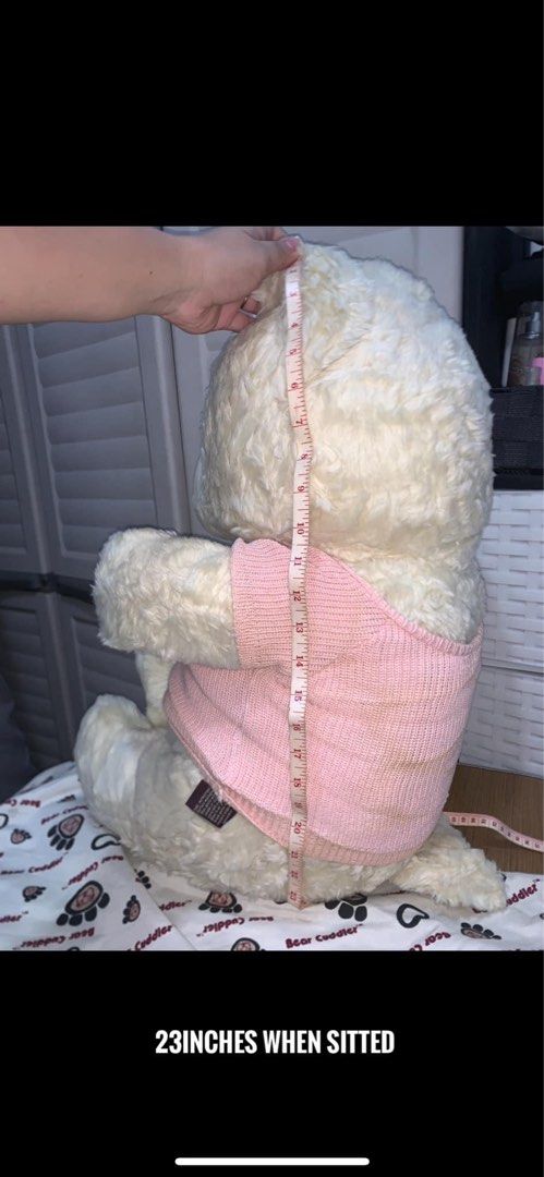 Bear Cuddler Teddy (Category: Plushies & Soft Toys) located in Manila. Submitted by mixi_lexi (Listing ID 1471080415, Image 2). Description: - Item: Bear Cuddler plush toy - Size: 23 inches (seated) - Features: Soft cream fur, sweet sleepy eyes, brown nose - Outfit: Comes with an adorable pink knit sweater.