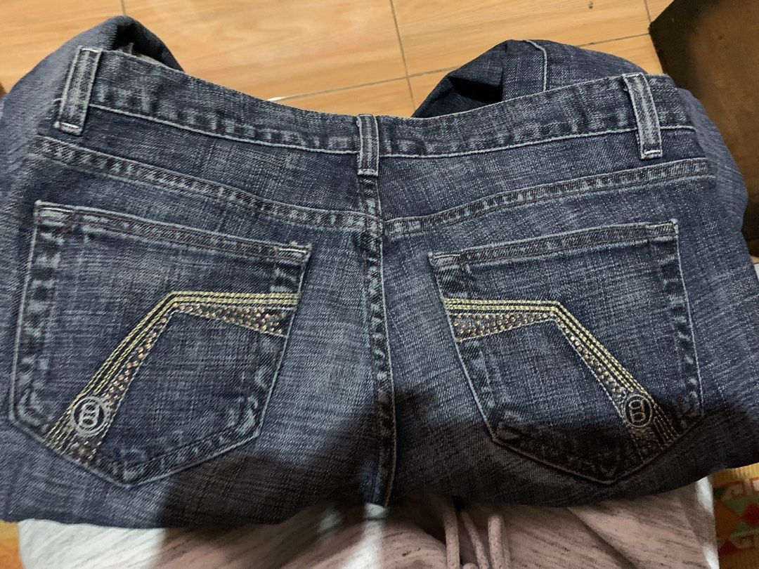 bebe Dark Wash Flare Jeans Size 27 (Category: Jeans) located in Davao. Submitted by sadthrift (Listing ID 1470964788, Image 3). Description: - Brand: bebe - Style: Dark wash denim flare jeans with low-rise fit - Size: 27 - Material: 98% cotton, 2% spandex (slight stretch) - Origin: Made in USA - Details: Rhinestone embellishments on back pockets, standard five-pocket styling, branded buttons and pocket lining - Condition: Excellent pre-loved cond