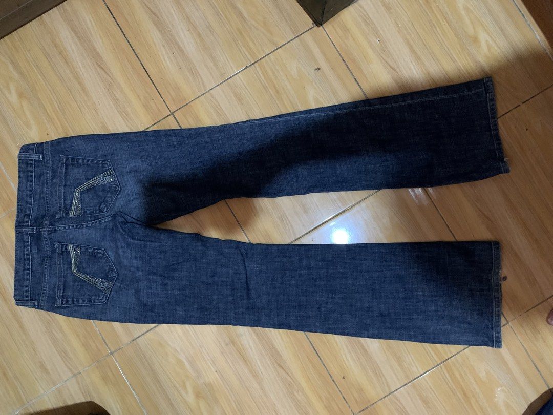bebe Dark Wash Flare Jeans Size 27 (Category: Jeans) located in Davao. Submitted by sadthrift (Listing ID 1470964788, Image 2). Description: - Brand: bebe - Style: Dark wash denim flare jeans with low-rise fit - Size: 27 - Material: 98% cotton, 2% spandex (slight stretch) - Origin: Made in USA - Details: Rhinestone embellishments on back pockets, standard five-pocket styling, branded buttons and pocket lining - Condition: Excellent pre-loved cond