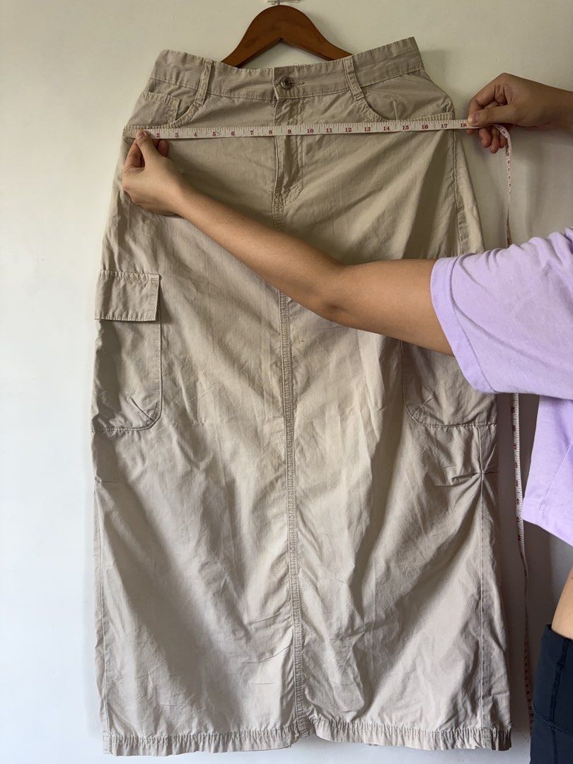 Beige Cargo Midi Skirt Y2K Utility Style (Category: Skirts) located in Muntinlupa City. Submitted by shopkidsandmom.ph (Listing ID 1471035990, Image 3). Description: - Color: Beige - Style: Utility midi skirt with straight cut hem - Features: Multiple cargo pockets, front button closure, and belt loops - Fit: Best fits Medium size - Condition: Great basic piece for casual everyday outfits - Note: Please check photos for exact measurements.