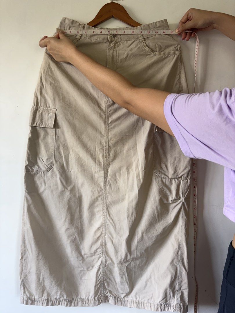 Beige Cargo Midi Skirt Y2K Utility Style (Category: Skirts) located in Muntinlupa City. Submitted by shopkidsandmom.ph (Listing ID 1471035990, Image 2). Description: - Color: Beige - Style: Utility midi skirt with straight cut hem - Features: Multiple cargo pockets, front button closure, and belt loops - Fit: Best fits Medium size - Condition: Great basic piece for casual everyday outfits - Note: Please check photos for exact measurements.