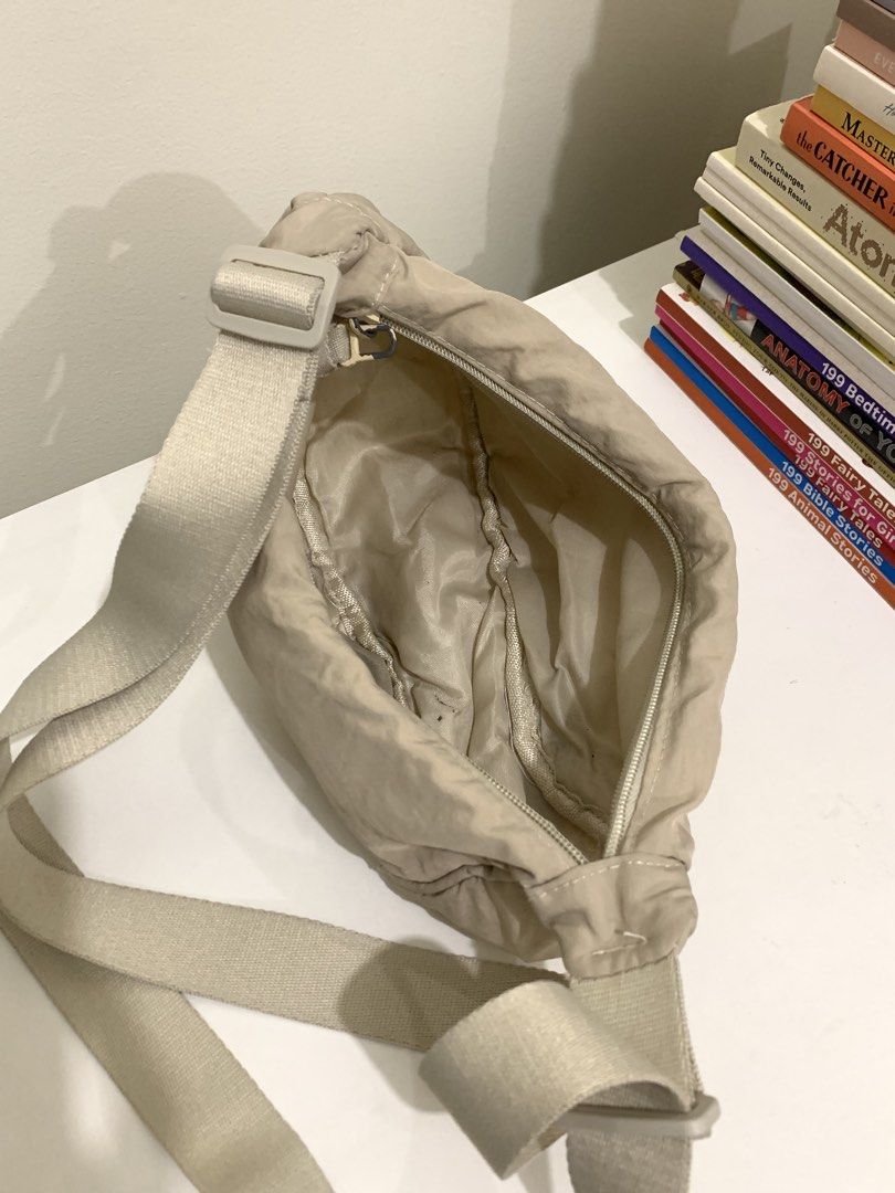 Beige crescent shoulder bag adjustable strap (Category: Cross-body Bags) located in Pasig City. Submitted by lovedbyri (Listing ID 1470949102, Image 3). Description: - Color: Neutral beige - Material: Soft fabric with lined interior - Closure: Zippered main compartment - Strap: Wide, adjustable canvas strap for shoulder or crossbody wear - Capacity: Good depth for everyday essentials - Condition: Light everyday wear.