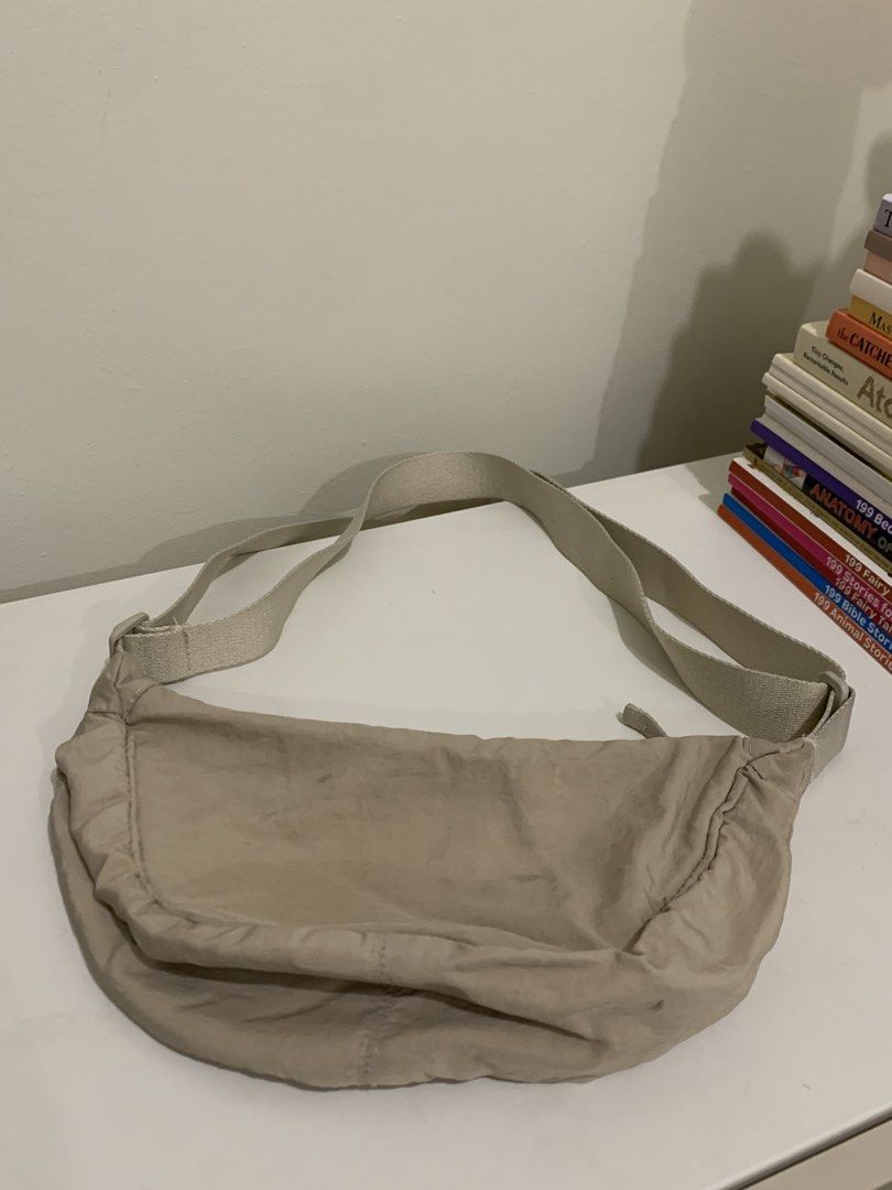 Beige crescent shoulder bag adjustable strap (Category: Cross-body Bags) located in Pasig City. Submitted by lovedbyri (Listing ID 1470949102, Image 1). Description: - Color: Neutral beige - Material: Soft fabric with lined interior - Closure: Zippered main compartment - Strap: Wide, adjustable canvas strap for shoulder or crossbody wear - Capacity: Good depth for everyday essentials - Condition: Light everyday wear.