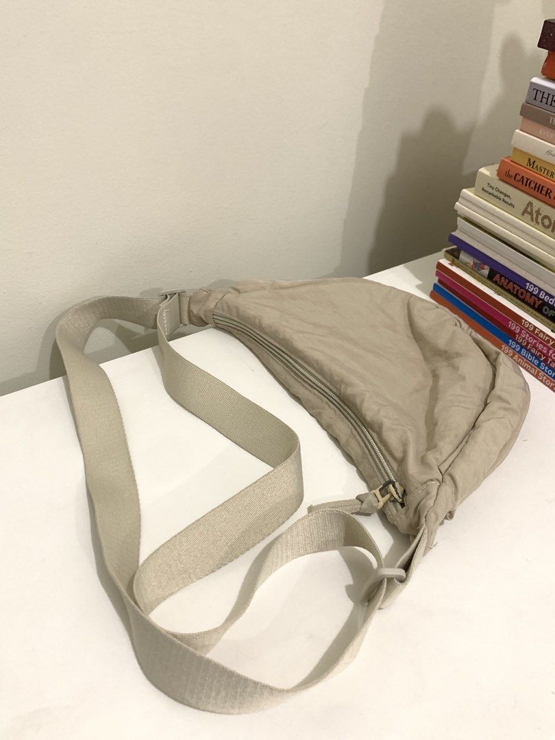 Beige crescent shoulder bag adjustable strap (Category: Cross-body Bags) located in Pasig City. Submitted by lovedbyri (Listing ID 1470949102, Image 2). Description: - Color: Neutral beige - Material: Soft fabric with lined interior - Closure: Zippered main compartment - Strap: Wide, adjustable canvas strap for shoulder or crossbody wear - Capacity: Good depth for everyday essentials - Condition: Light everyday wear.