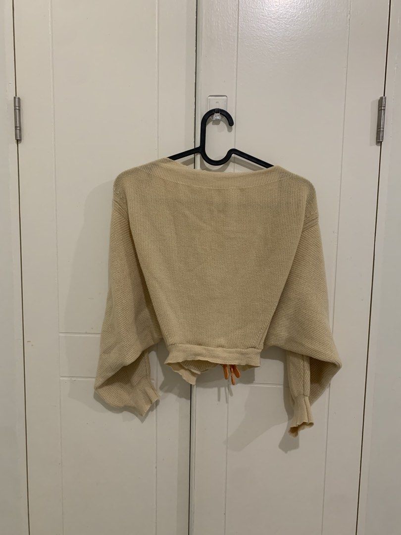 Beige Knit Cropped Cardigan Sweater (Category: Coats, Jackets and Outerwear) located in Pasig City. Submitted by lovedbyri (Listing ID 1471003953, Image 3). Description: - Color: Beige - Style: Cropped cardigan with V-neckline and long sleeves - Fabric: Soft, lightweight ribbed knit - Condition: Worn a few times, very good shape - Best for: Versatile layering over tanks, tees, and dresses.