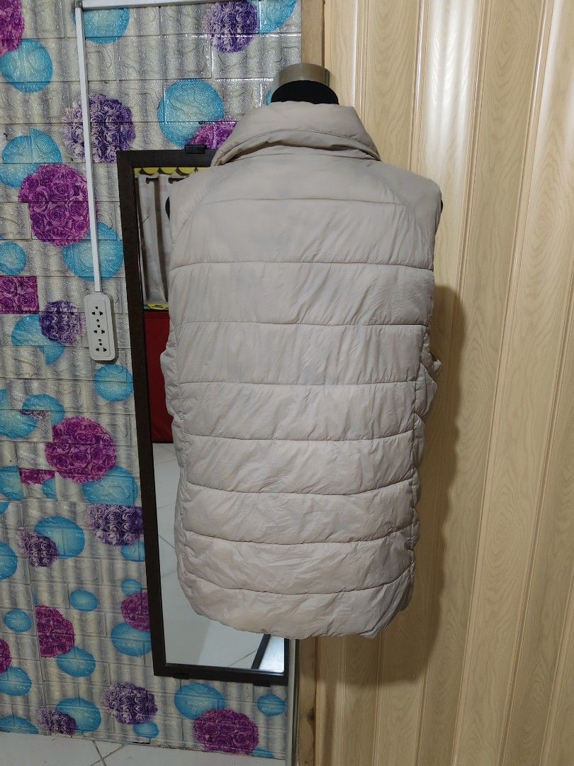 Beige Quilted Puffer Vest Asymmetric Zip (Category: Sleeveless) located in Manila. Submitted by duffy-080 (Listing ID 1470989228, Image 3). Description: - Color: Neutral beige / cream - Design: Quilted diagonal stitching with trendy asymmetric zipper - Features: Warm high collar and two functional side pockets - Style: Sleeveless, ideal for layering over long sleeves - Condition: Brand new / excellent (ready to ship!).