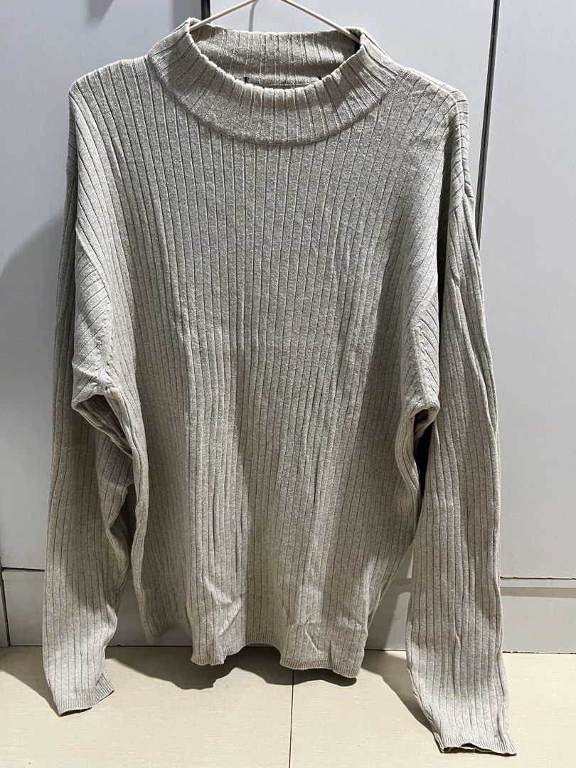 Beige Ribbed Turtleneck Long Sleeve Sweater (Category: Longsleeves) located in Caloocan City. Submitted by decluttering.101_ (Listing ID 1471038143, Image 1). Description: - Color: Neutral beige - Material: Soft-textured ribbed knit - Fit: Relaxed fit with long sleeves - Neckline: High mock neck - Style: Versatile layering piece for cold weather.