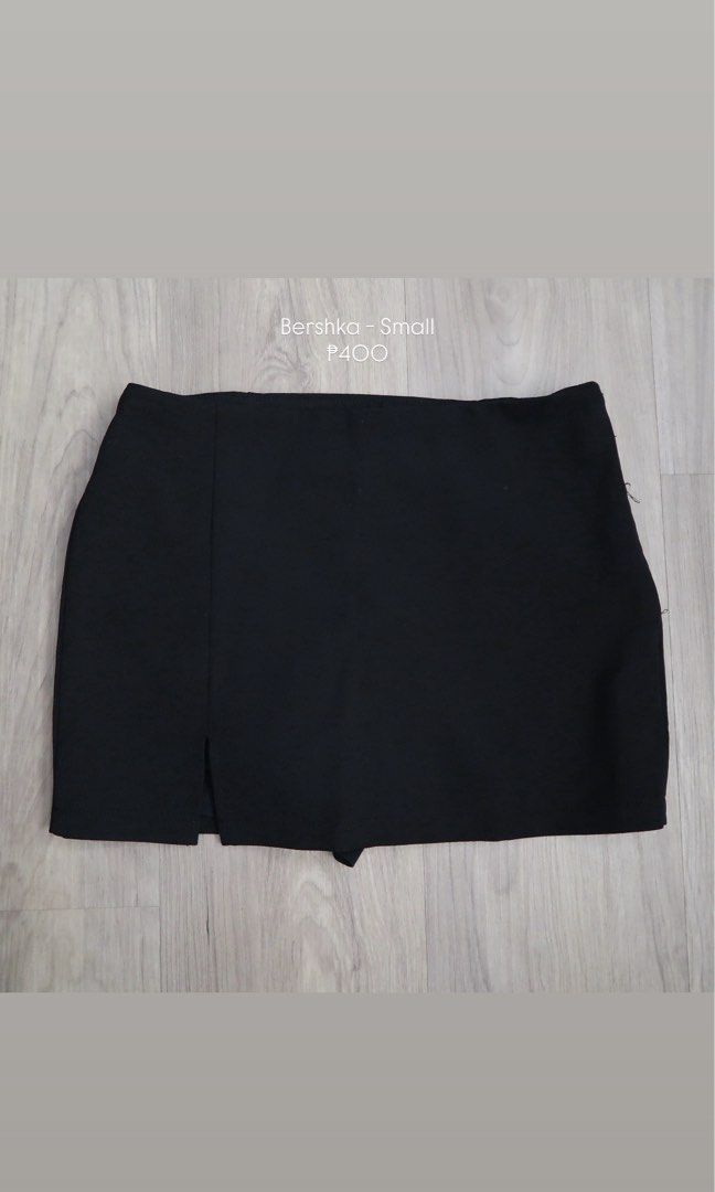 Bershka Black Skort Small (Category: Skirts) located in Manila. Submitted by mixi_lexi (Listing ID 1471022615, Image 1). Description: - Brand: Bershka - Size: Small (S) - Color: Classic solid black - Design: Stylish front slit on the left side - Comfort: Tailored skirt look with built-in shorts - Versatility: Perfect for casual days or dressed-up nights out.